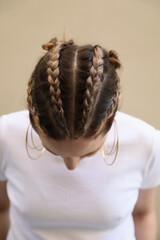 Vertical portrait of beautiful young blond woman with braid hairstyle. 