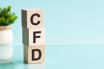 CFD abbreviation - Contract For Difference, on wooden cubes on a light background.