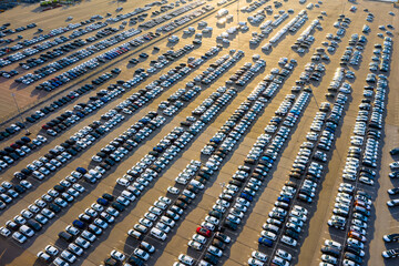 Aerial view of the dealership or customs terminal parking lot with a rows of new cars © Golden eagle
