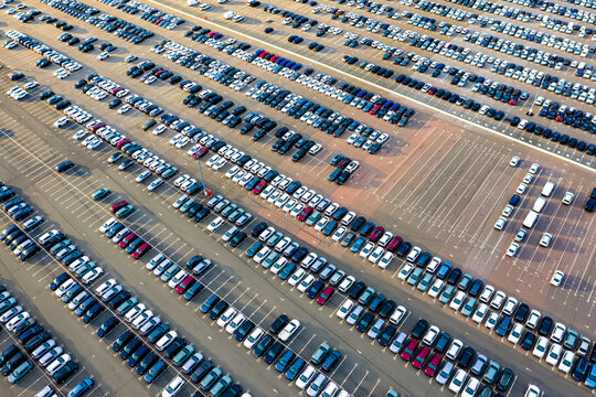 Aerial View Of The Dealership Or Customs Terminal Parking Lot With A Rows Of New Cars