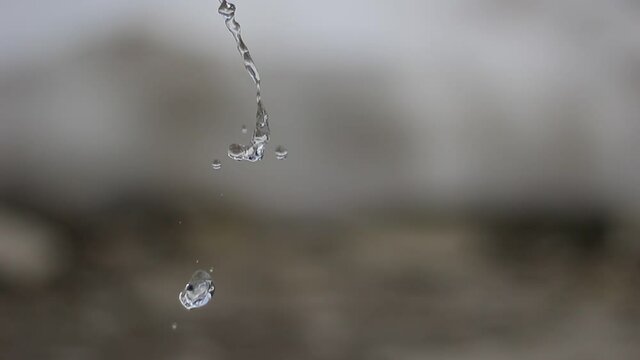 Flowing drops of water are falling.