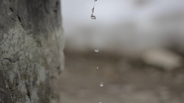 Flowing drops of water are falling.
