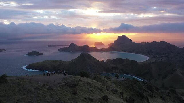 2020 - Excellent aerial shot of tourists enjoying the view of sunset from Padar Island within Komodo National Park in Indonesia.