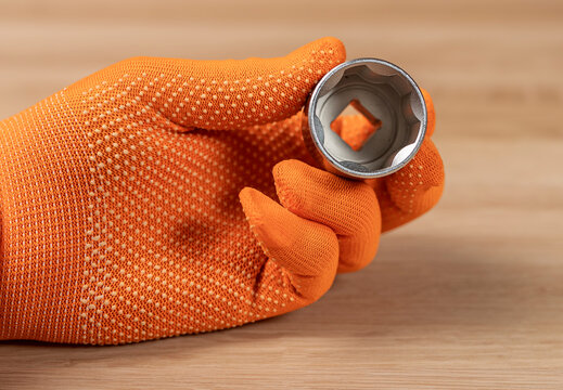 Hex socket, hexagon metal head for building tool in male hand.