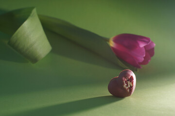 Romantic gifts chocolate heart and pink tulips