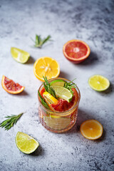 Red orange lime lemon cocktail in a glass