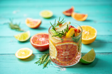 Red orange lime lemon cocktail in a glass