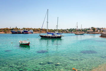 Obraz premium The port and the old shipyard in Spetses, Greece. Spetches is a picturesque small island in Saronic gulf, where superyachts bob up and down next to traditional wooden fishing boats.