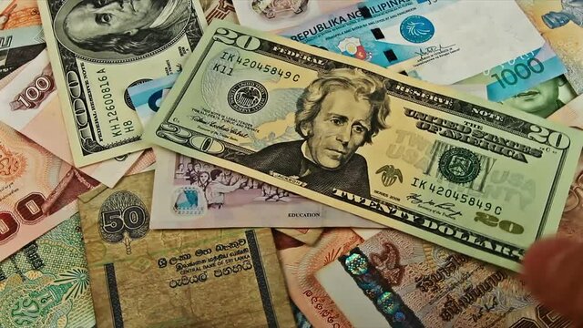 Cash money background closeup rotation. US dollar, euro, ruble, baht, peso, rupee banknotes