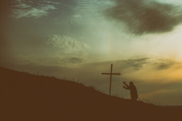 Old man kneel before Jesus cross - 428887353