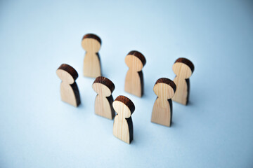 Wooden figure standing with team