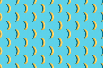 Bananas on a blue background. Seamless banana pattern. Seamless texture. Hard shadows.