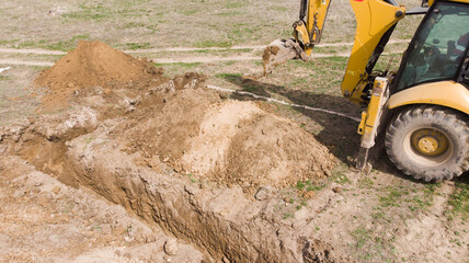 The tractor digs the foundation