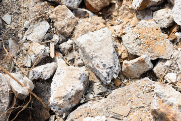 The consequences of the earthquake. Large concrete blocks crushed. Remains of a building with rebar. 