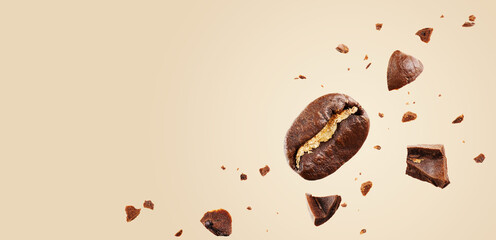 Mockup with flying coffee beans in the air among ground coffee on a beige background. Concepts of levitation. banner with copy space.