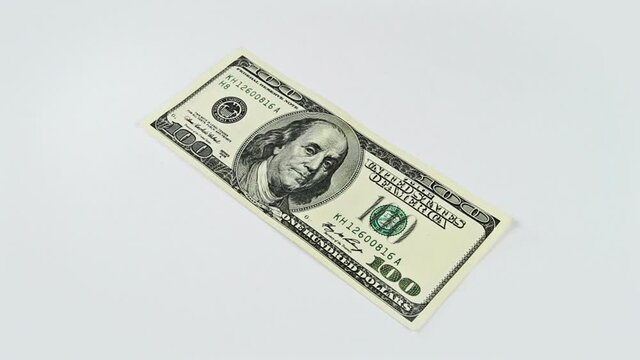 Cash money background. Benjamin Franklin portrait on 100 US dollar bill close up rotation