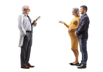 Full length profile shot of a young couple talking to a gynecologist