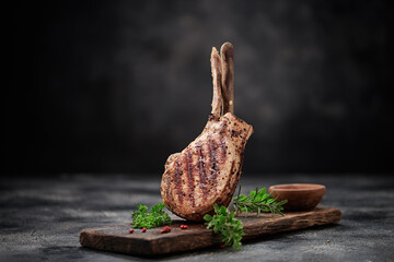 Grilled pork meat with bone on wooden board
