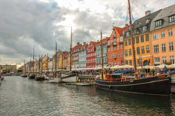 View of the famous Nyhavn, Copenhagen, Denmark, with the canal and moored sailboats