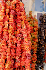 Dry eggplant and dry bell chili hanging on sale at shop. Food background.