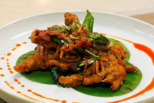 indian street snack crispy battered fried pakoda or pakora in a plate with modern garnish