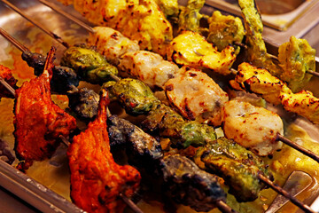 multi coloured and flavoured indian tandoori kebabs or tikka in a skewer, authentic cuisine