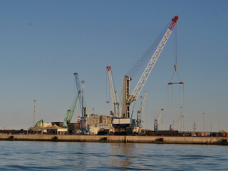 Fototapeta na wymiar industrial port with ship and heavy duty crane brindisi. 