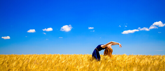 Redhead girl on wheat field in summer  © Masson