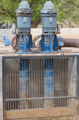 A pair of pumps along an acequia, or irrigation ditch, in the pecan groves of New Mexico
