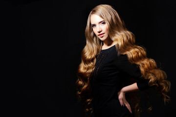 Fototapeta na wymiar Luxurious golden curls, portrait of a young beautiful woman with beautiful hair,
