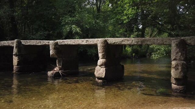 Old stone footbridge over the Neiva River in Antas, Esposende, Portugal.