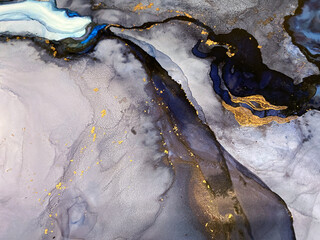 Abstract blue art with gold — fluid background with beautiful smudges and stains made with alcohol ink and golden pigment. Blue with violet texture resembles natural materials, watercolor or aquarelle