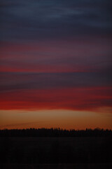 Pink sky after sunset. Red clouds in the light of the sunset.