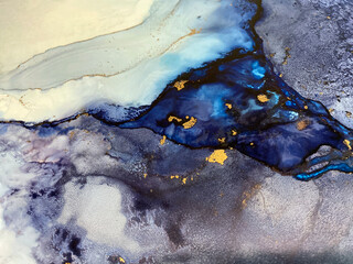 Abstract blue art with gold — fluid background with beautiful smudges and stains made with alcohol ink and golden pigment. Blue with violet texture resembles natural materials, watercolor or aquarelle