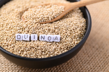 Brown quinoa seeds in a bowl with spoon, Edible seeds are high protein, Healthy food