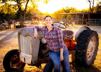Farm girl on tractor at sunset