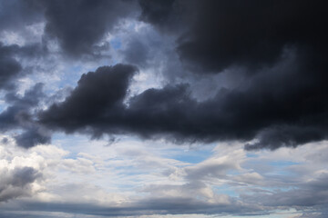 Epic dramatic Storm sky, dark grey and white cumulus clouds on blue sky background texture	
