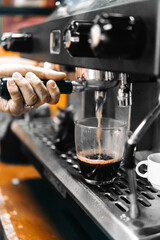 Hand pulling a lever that takes out black / American coffee.