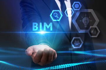 Business, Technology, Internet and network concept. Young businessman working on a virtual screen of the future and sees the inscription: BIM