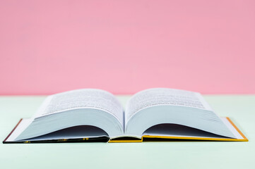 Open book on a coloured background