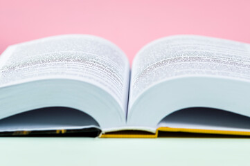 Open book on a coloured background