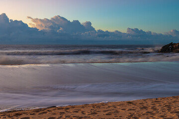 Fototapeta na wymiar Sunrise at the seaside with low cloud bank