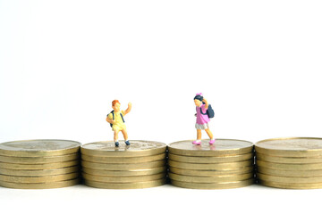 School admission budget.  Children or kids, walking above golden coin money stack. Miniature tiny people toys photography. isolated on white background.