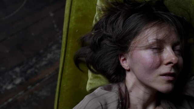 excited middle-aged woman is caressing herself in room, closeup of face