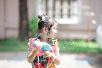 Blurred background view of asian girl They are playing in the water for Songkran within the family, having a fun run and fun during the day.