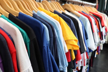 Close up of colorful tee shirts hanging on store racks