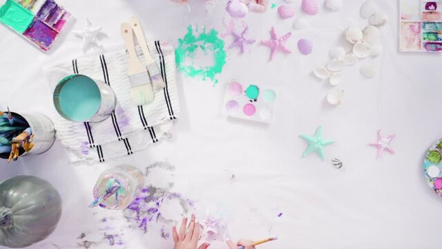 Flat lay. Step by step. Painting craft pumpkin with acrylic paint to create decorated mermaid Halloween pumpkin.