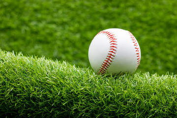 Baseball is on green grass background