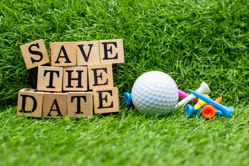Gordijnen Golf Save the Date with tee and golf ball on green grass background © thaninee