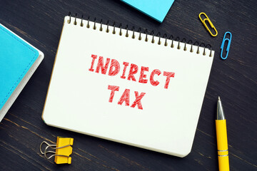Financial concept about INDIRECT TAX with phrase on the piece of paper. Indirect taxes can be defined as taxation on an individual or entity